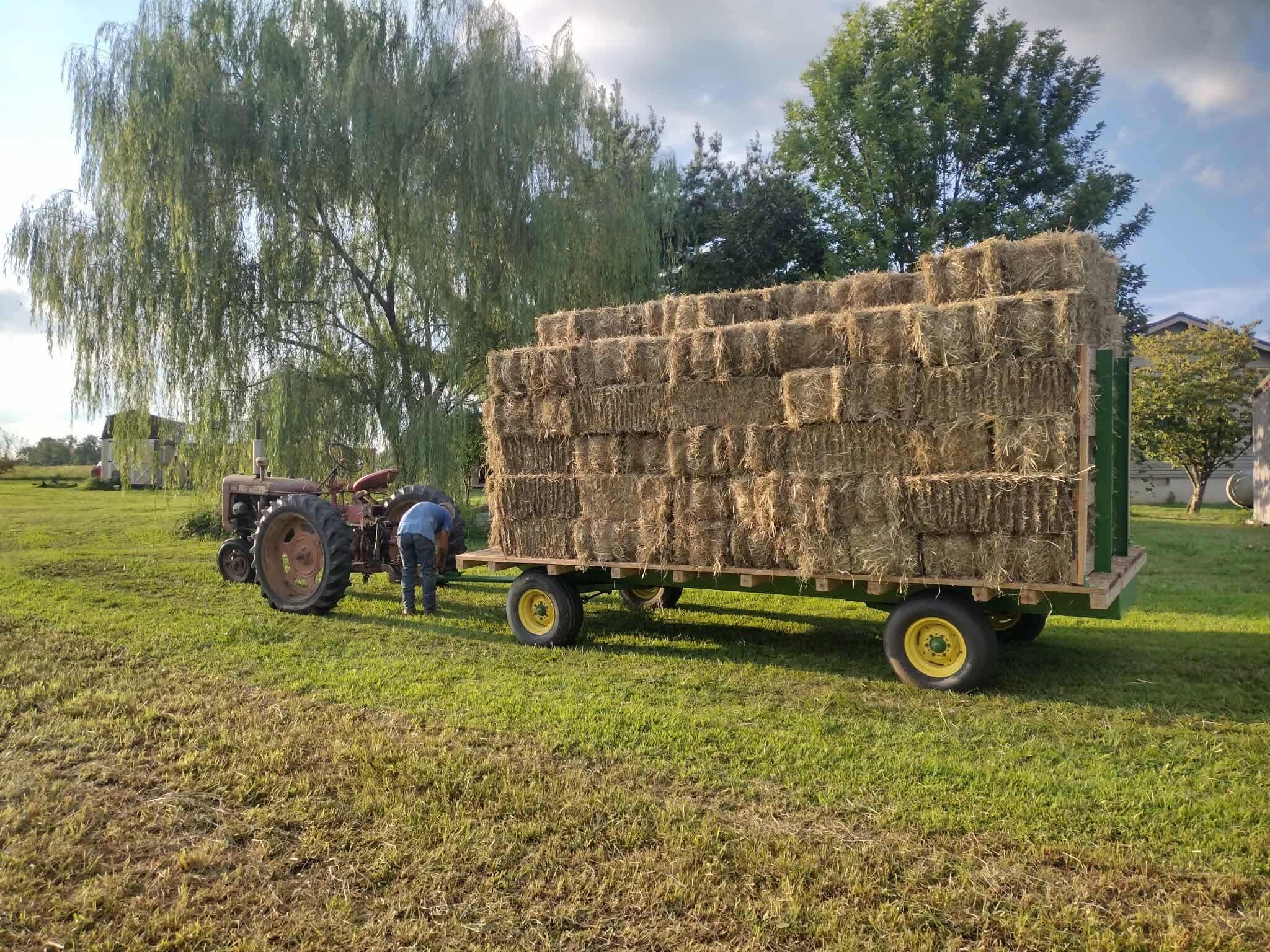 Hay wagon hitched to a tractor on a sunny day